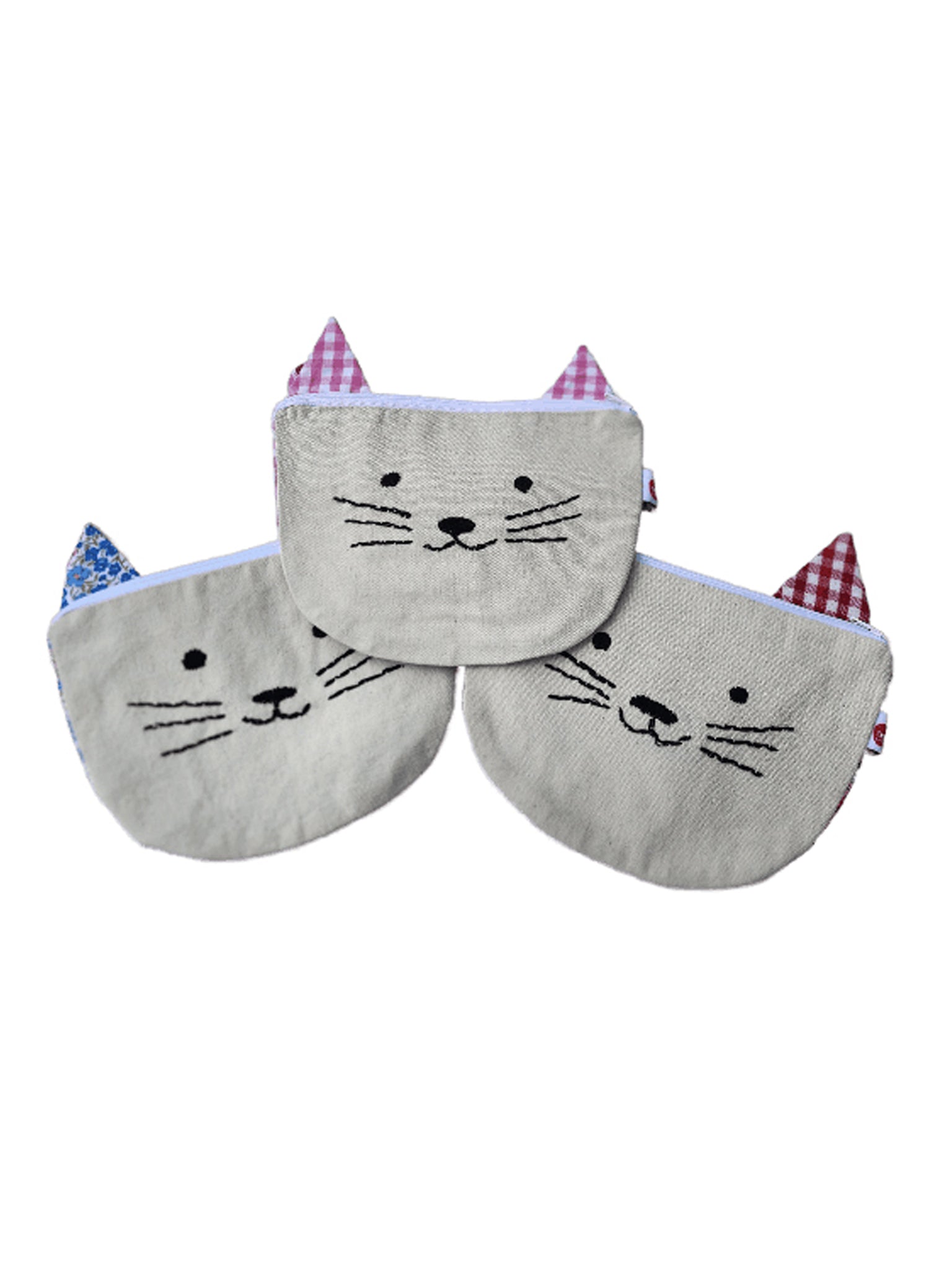 Three "Cat Bag" fabric pouches by Oobi, designed in the shape of cat faces with embroidered whiskers and noses, featuring red and blue plaid ears.