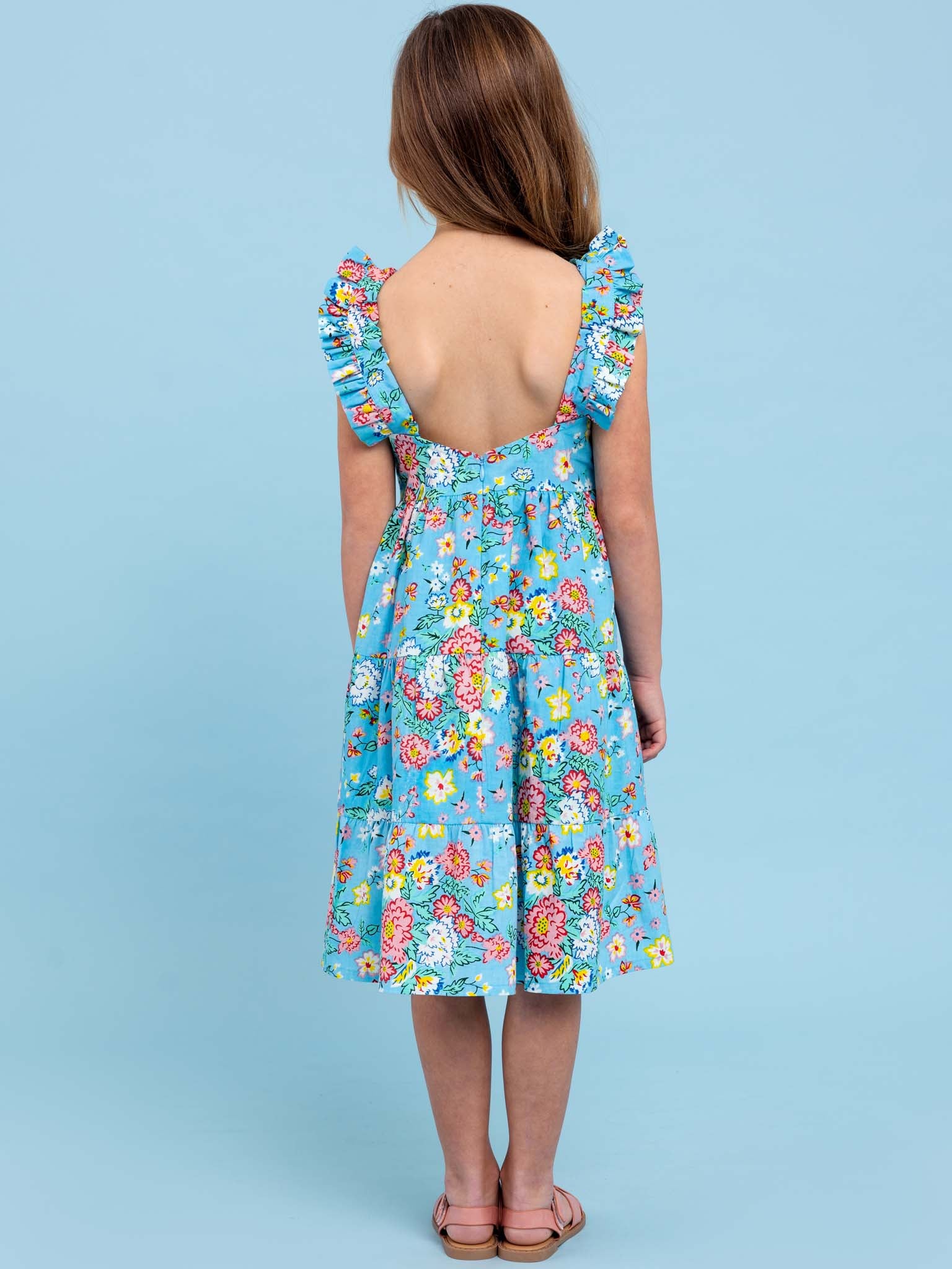 The back view of a girl in a Cornflower Meadow Midi-Maxi Dress by Cornflower brand.