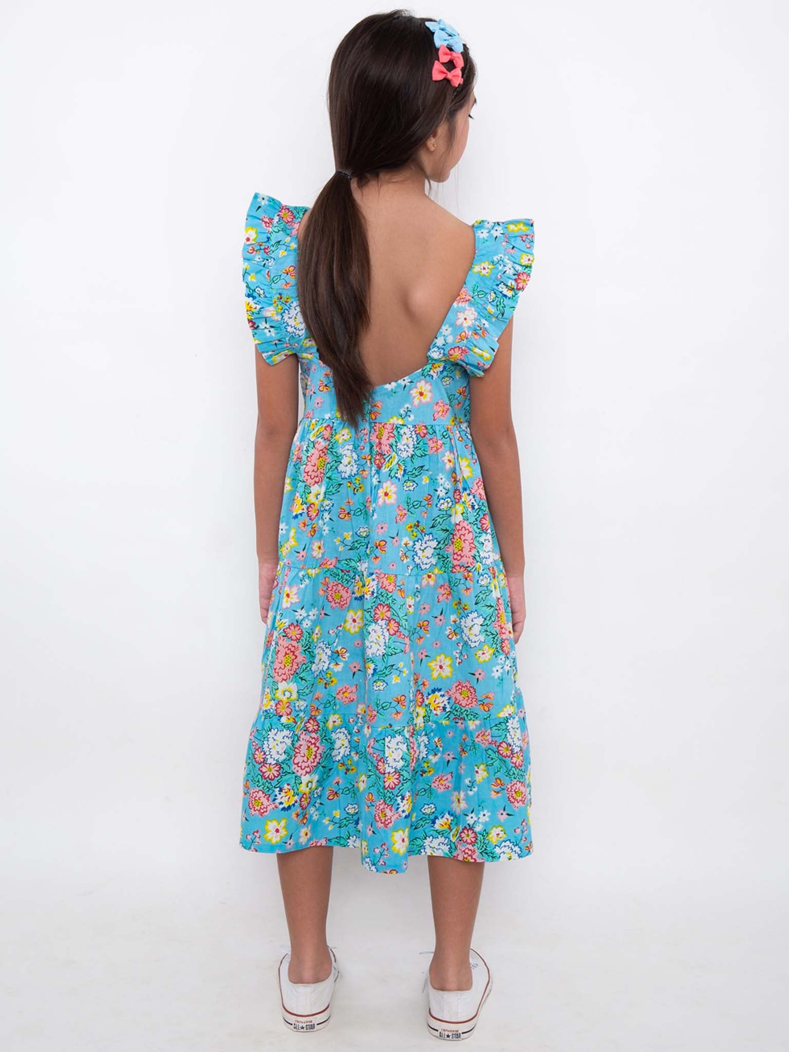 The back view of a girl in a Cornflower Meadow Midi-Maxi Dress by Cornflower.