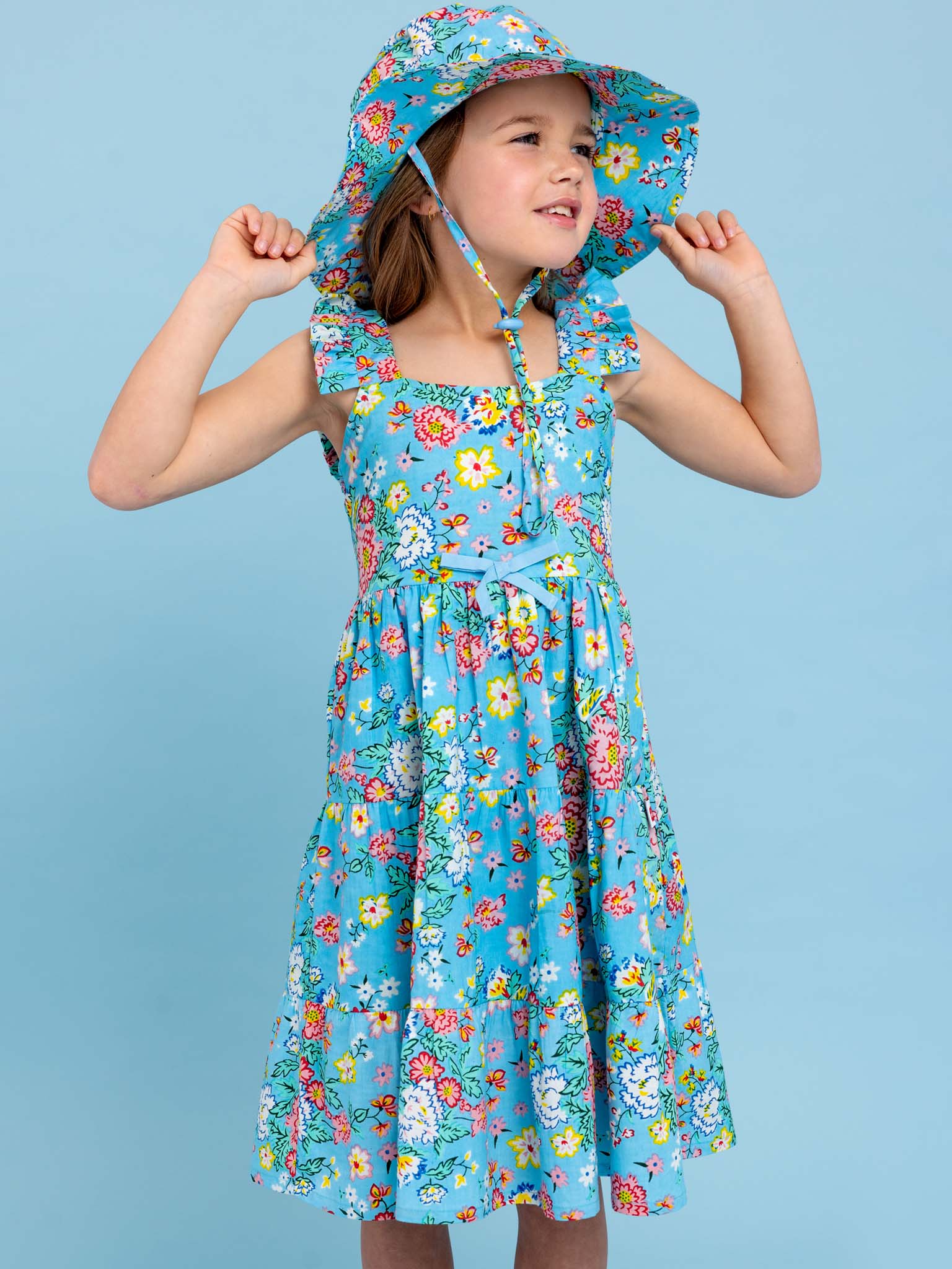 A little girl wearing a Cornflower Meadow Midi-Maxi Dress by Cornflower.