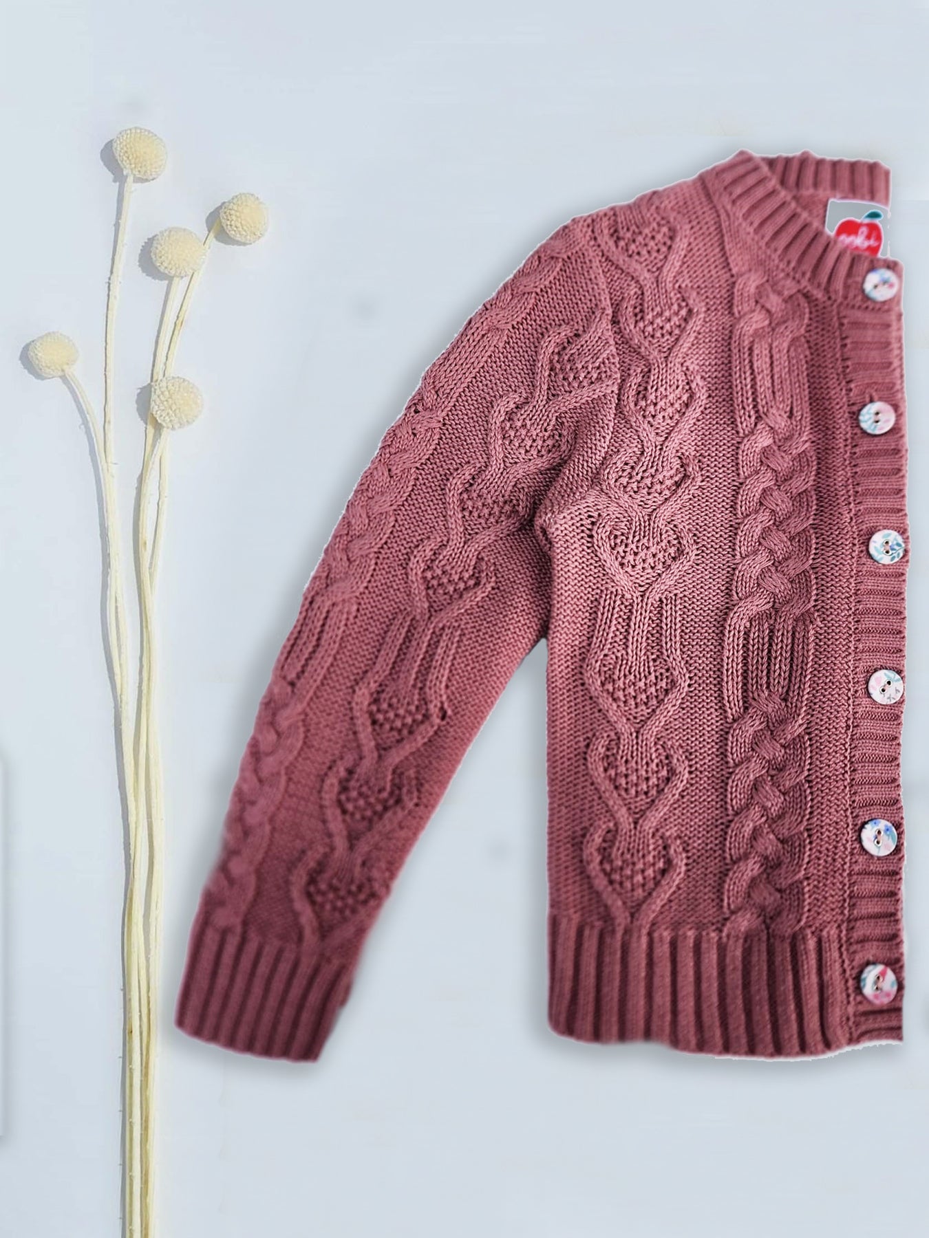 A Willow Cotton Cardigan Rose Garden by Knitwear, with fabric covered buttons and flower details, perfect for a cozy winter's day.