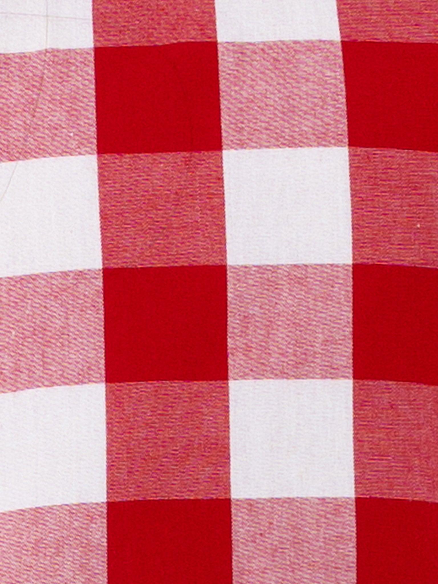 A close-up of an oversized ruffle sleeve on a Red Check Jayne Dress with a gingham waistband, known as the Jayne dress.