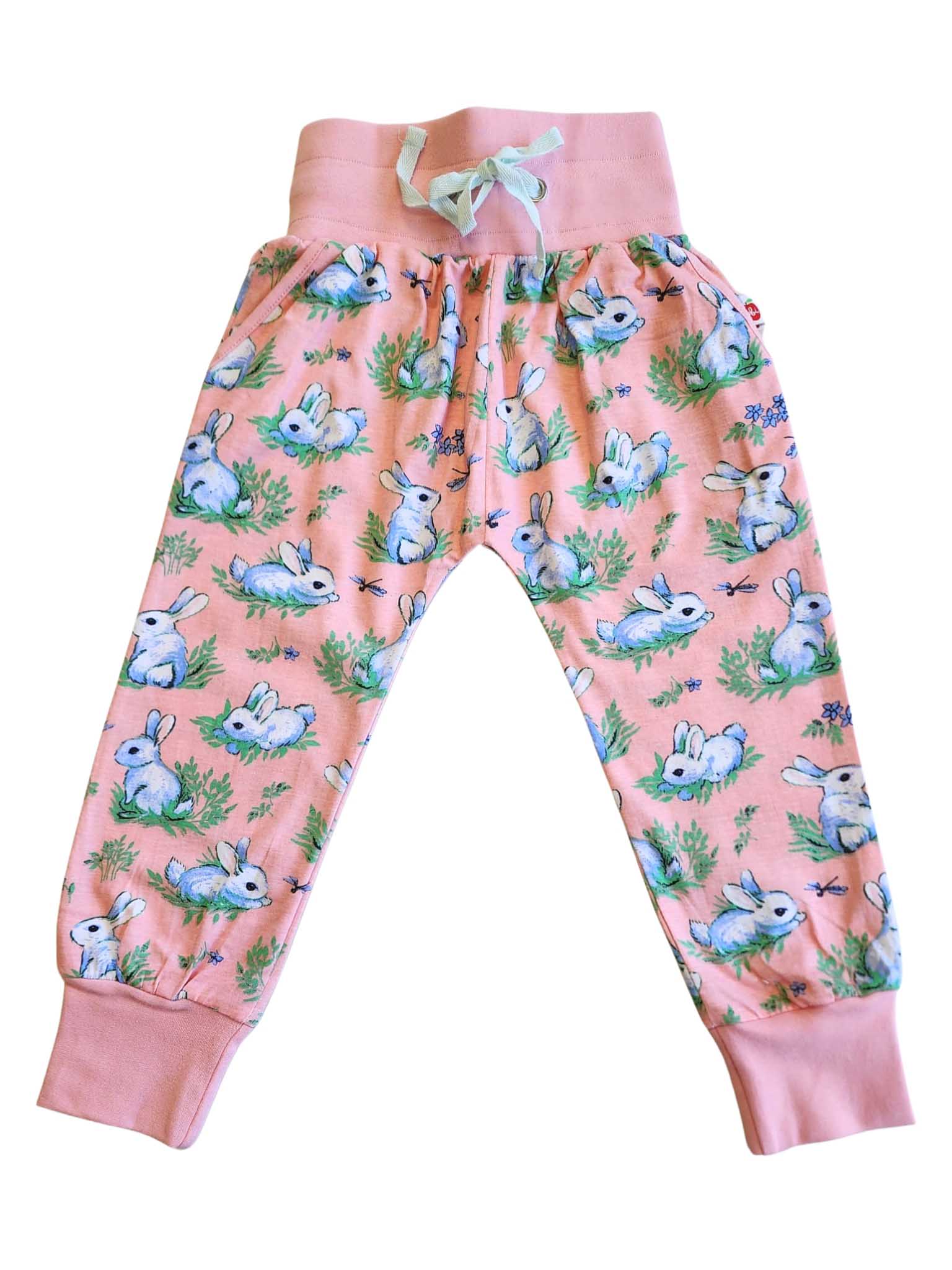 The Bun-Buns "Bun Bun Soft Jersey Pants" are soft, pink pants with a drawstring waist and feature an adorable print of white bunnies and green foliage. Perfectly paired with the Zadie Jacket, these children's pants have become a best seller!.