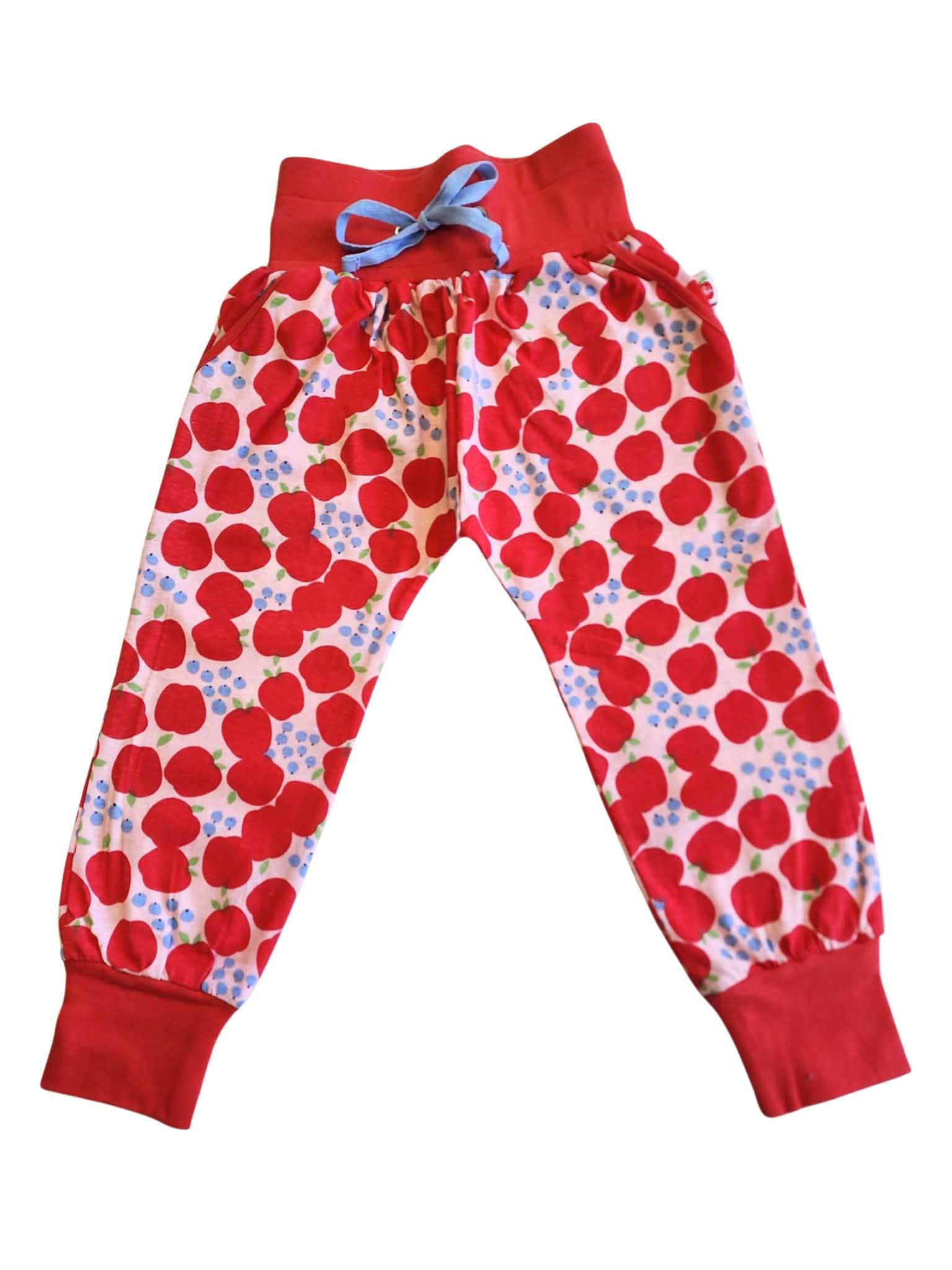 The Sweet Apple Soft Jersey Pants for children are red and white patterned with an elastic waist, red cuffs, and a blue drawstring. Crafted from soft jersey fabric, these best-selling pants by Sweet Apple promise comfort and style in one delightful package.