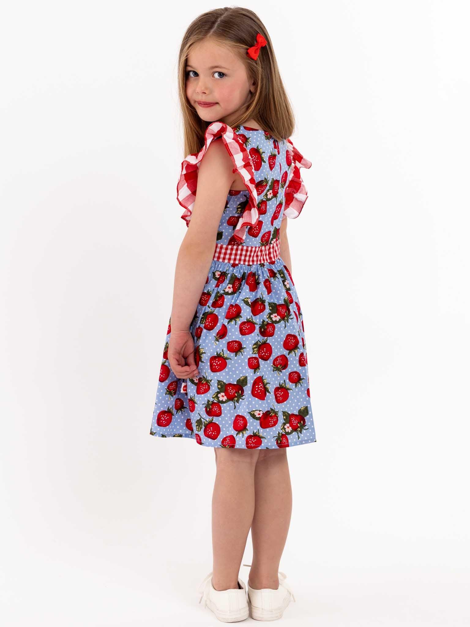 A little girl wearing a Strawberry Fields Jayne dress.